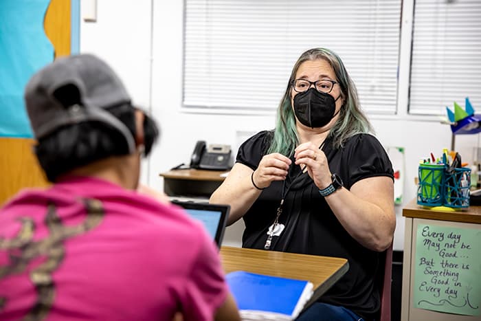 
ASL interpreter Jennifer Somerville signs for a hard of hearing student.