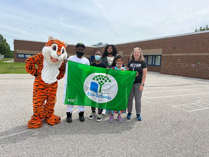 Guilford ES students hold an Eco-Schools banner with the GES staff.