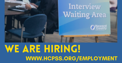 Photo showing poster reading, Interview Waiting Area. Blue background with yellow text stating, We are hiring! www.hcpss.org/employment