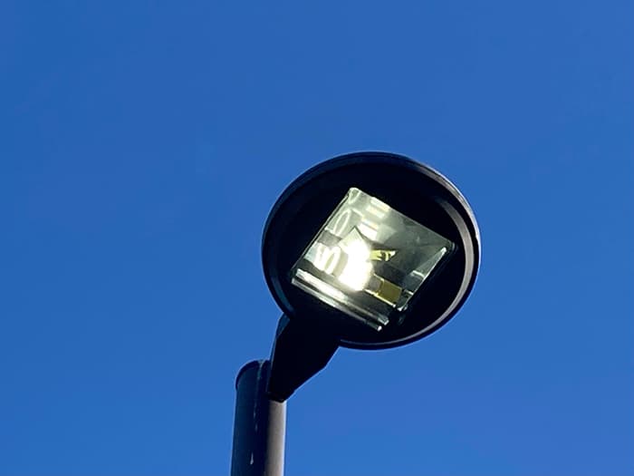 New LED light installed in a school parking lot light pole.