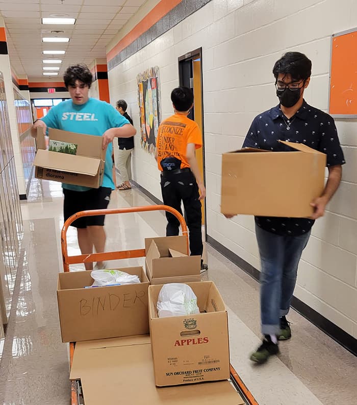 Students carrying boxes of food