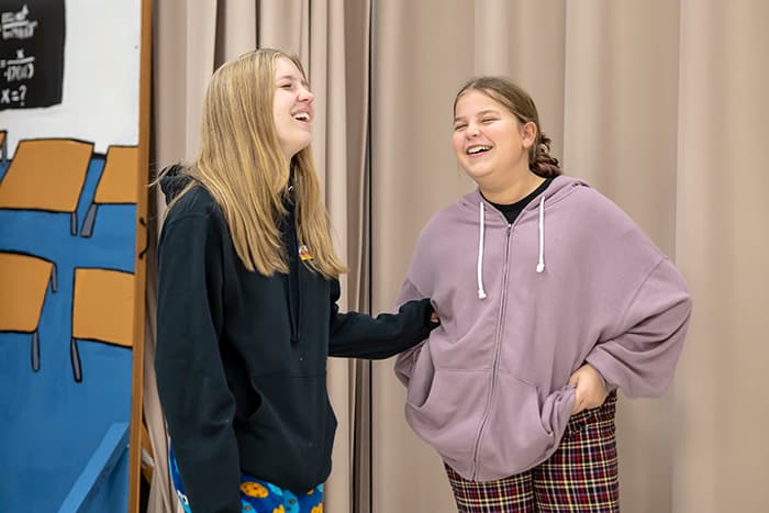 Two female students laughing in their PMS theatre class.