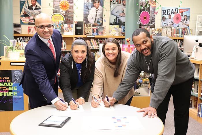 Columbia Community Care and HCPSS staff sign a new partnership agreement.