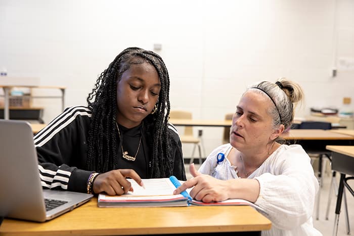 Reading Specialist Kellie Frey works with a LEMS student on a reading activity.