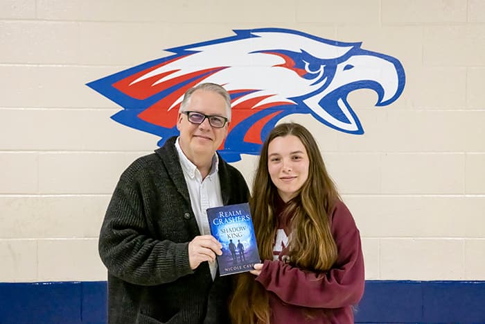 Rus VanWestervelt and Nicole Cavey in front of the CHS mascot.