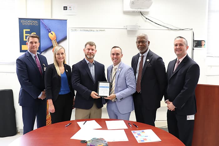 Educational Systems Federal Credit Union and HCPSS staff sign a new partnership agreement.