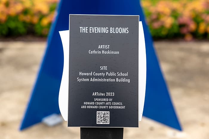 The Evening Blooms sign in front of the Department of Education.