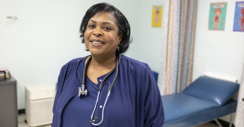 A school nurse smiling.