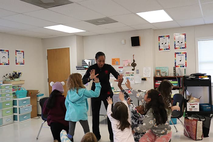 Monique Washington-Jones giving high fives to DRES students.