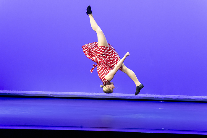 A GPHS dancer doing a flip in the air.