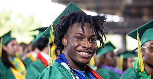 A male student wearing a graduation cap.