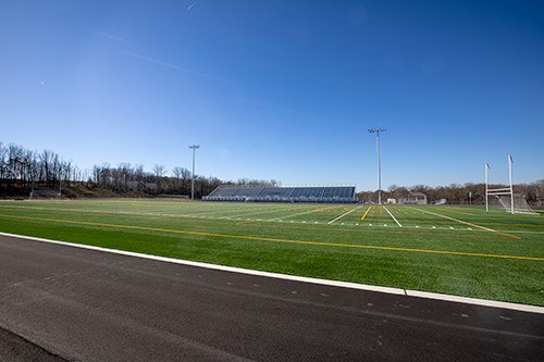 Photo showing portion of empty football field and track at Guilford Park High School 