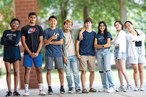 a group of diverse students posing for a photo in front of Marriotts Ridge High School