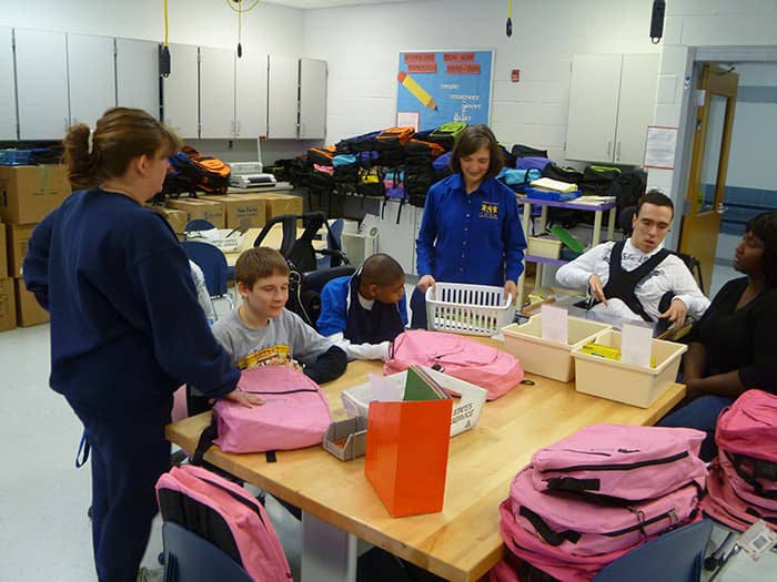 Cedar Lane School students packing supplies for Prepare for Success.