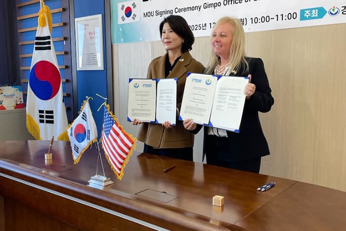 Jen Robinson and a rep. from Gimpo District of Education holding MOUs.