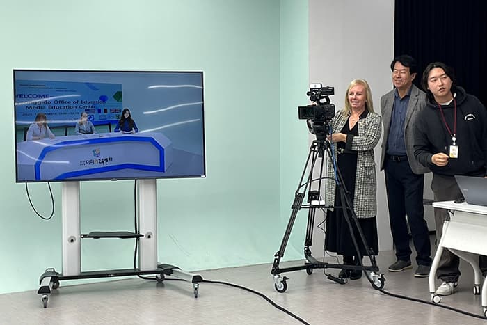 Jen Robinson behind a video camera in a South Korean classroom.