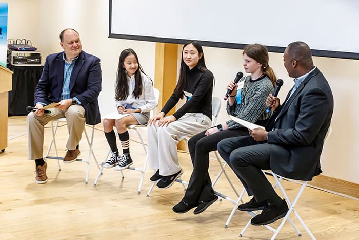 Superintendent Barnes and Calvin Ball interview a panel of students at the Climate Summit.