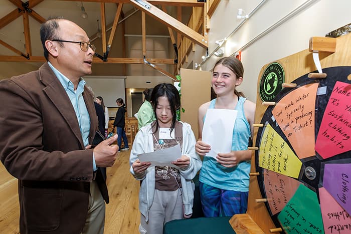 Students sharing their Climate Summit project with Board of Education member Dr. Linfeng Chen.
