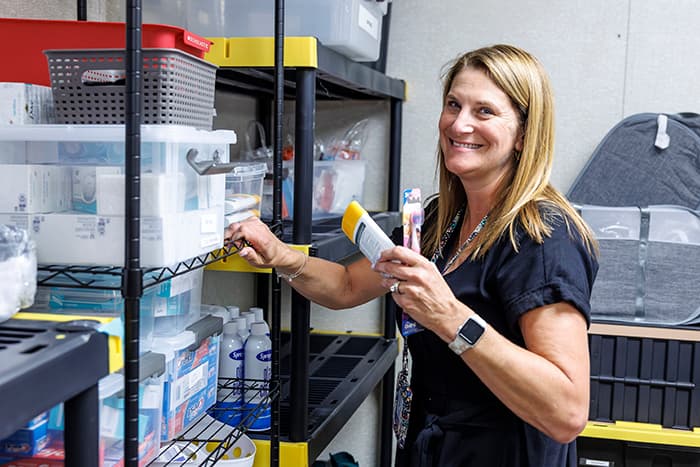 Alesia Richter holding personal supplies.