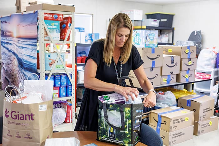 Alesia Richter packing a bag of supplies.