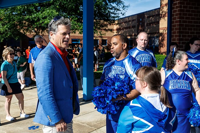 Special Olympics International Chairman of the Board Tim Shriver speaking with Howard HS cheerleaders at Challenge Day.