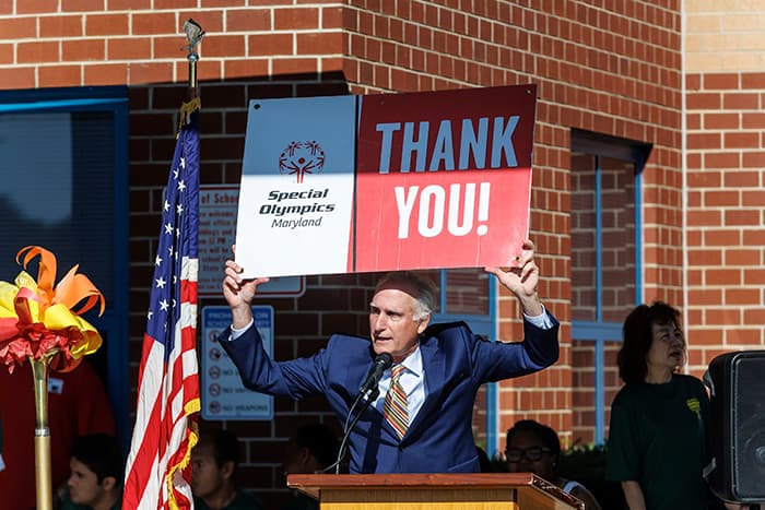President and CEO Special Olympics Maryland Jim Schmutz holds up a Thank You sign at Cedar Lane Challenge Day.
